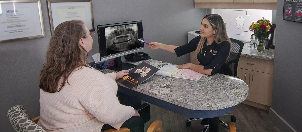 Implant Consultation with patient and administrator at Dr. Berzin Dental Implants